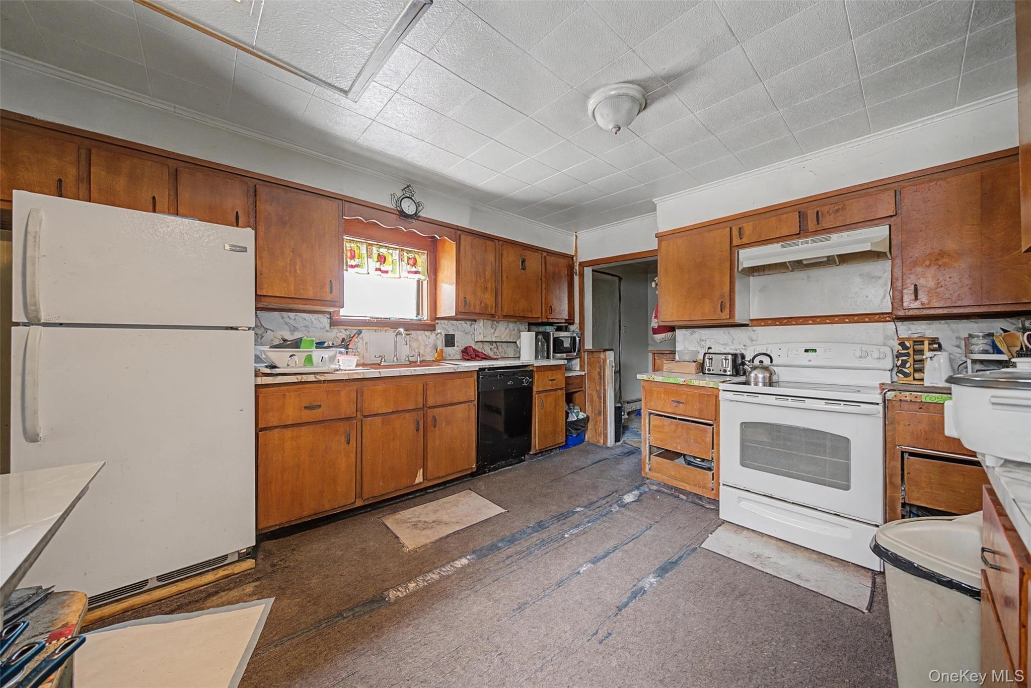 2 Station Hill Road, Unit 4 Ferndale, NY 12734 - Photo 10 of 25 Kitchen with white appliances, wood finish cabinetry, light countertops, and ornamental molding