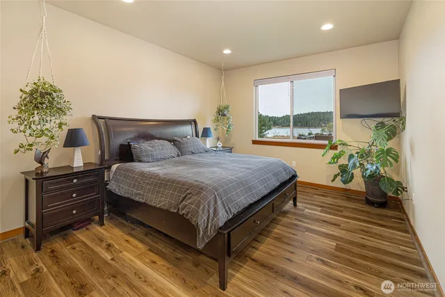 a bed sitting in a spacious bedroom next to a window