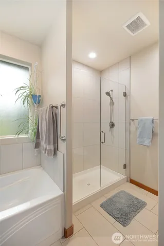 a bathroom with a tub and a shower