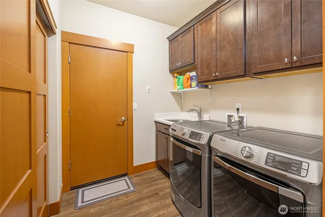 a kitchen with stainless steel appliances a stove a chimney and a cabinets