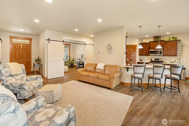 a bedroom with furniture and a wooden floor