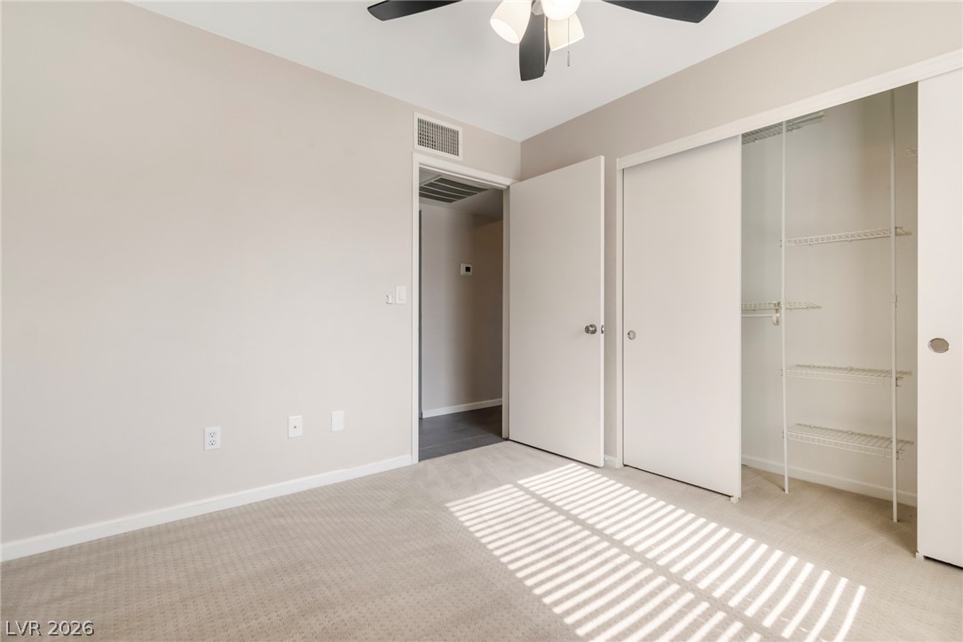 8070 West Russell Road, Unit 2006 Las Vegas, NV 89113 - Photo 20 of 24 A well-lit bedroom features plush carpeting and convenient closet storage.