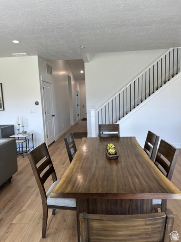 7927 Bristlecone Road, Unit 204 Eagle Mountain, UT 84005 - Photo 3 of 19 Dining area featuring light wood-style floors, a textured ceiling, and recessed lighting
