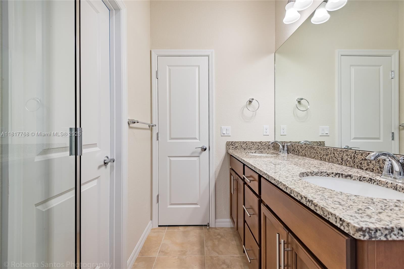 1040 Eucalyptus Drive, Unit 6 Hollywood, FL 33021 - Photo 20 of 41 a bathroom with a granite countertop sink and a mirror