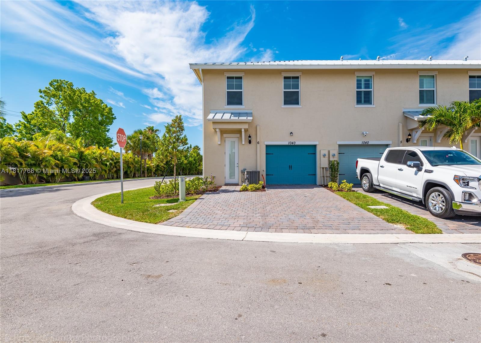 1040 Eucalyptus Drive, Unit 6 Hollywood, FL 33021 - Photo 32 of 41 a view of a white house with a small yard and a large parking space