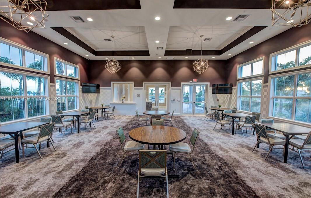 1040 Eucalyptus Drive, Unit 6 Hollywood, FL 33021 - Photo 41 of 41 a room with lots of tables a large window and chairs