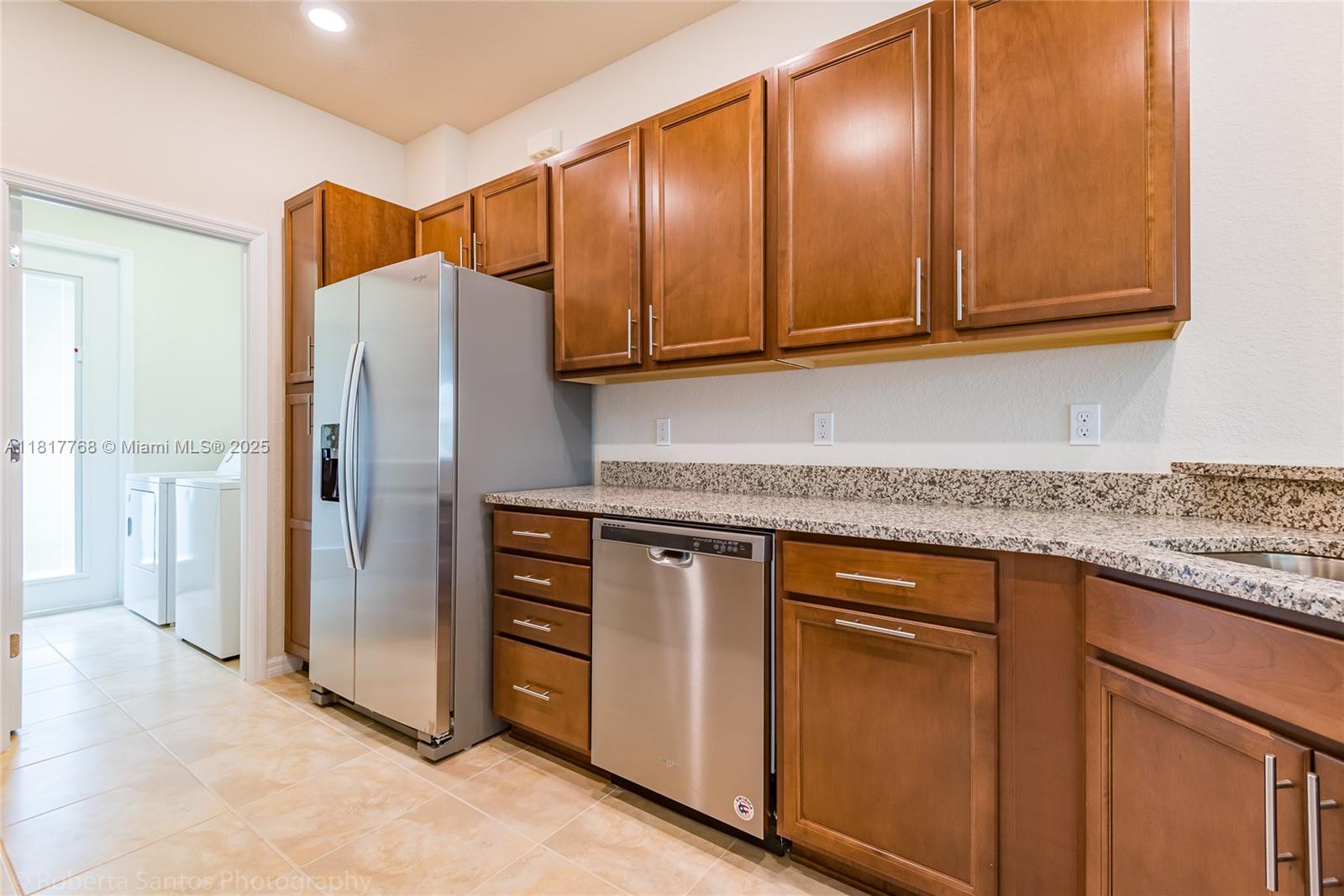 1040 Eucalyptus Drive, Unit 6 Hollywood, FL 33021 - Photo 7 of 41 a kitchen with stainless steel appliances granite countertop cabinets and a refrigerator