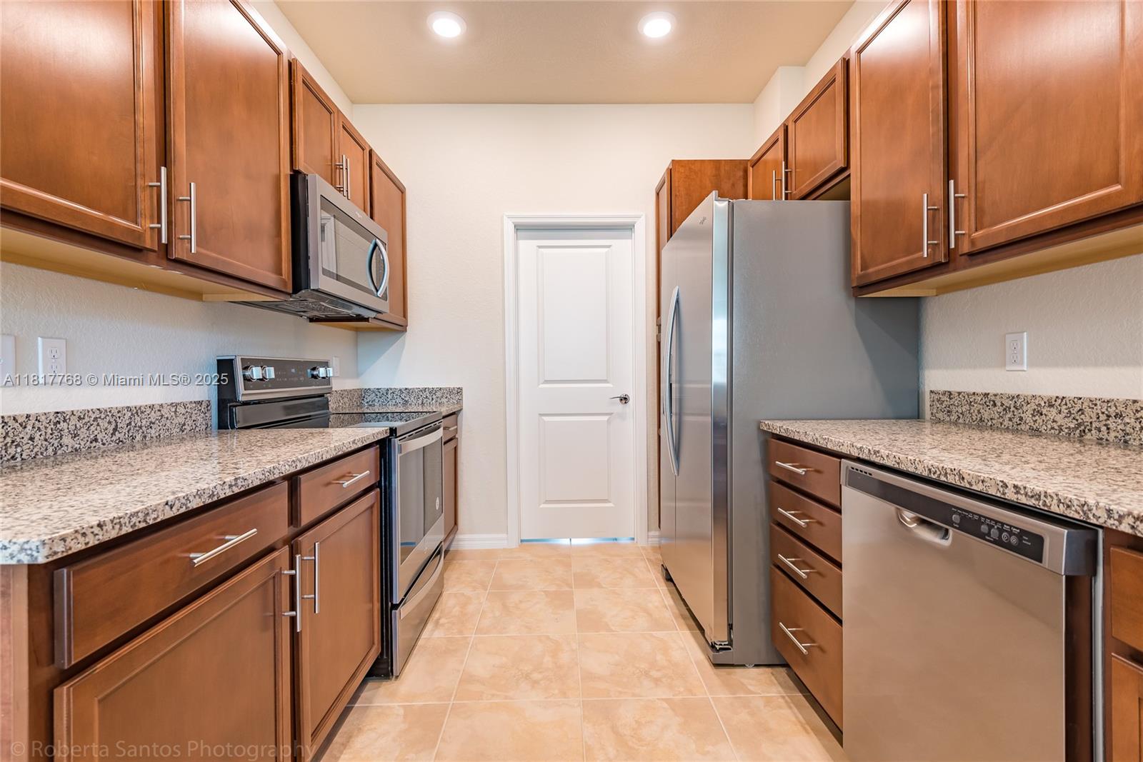 1040 Eucalyptus Drive, Unit 6 Hollywood, FL 33021 - Photo 8 of 41 a kitchen with stainless steel appliances granite countertop a refrigerator and a sink