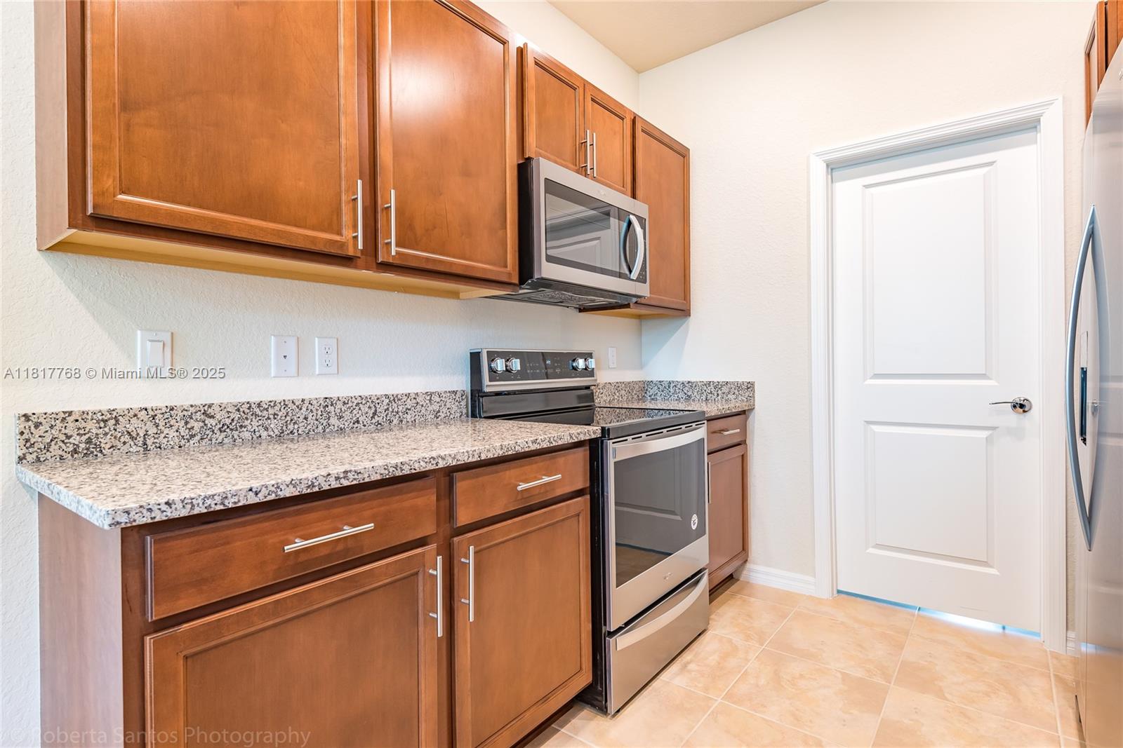 1040 Eucalyptus Drive, Unit 6 Hollywood, FL 33021 - Photo 9 of 41 a kitchen with stainless steel appliances granite countertop a sink and a microwave