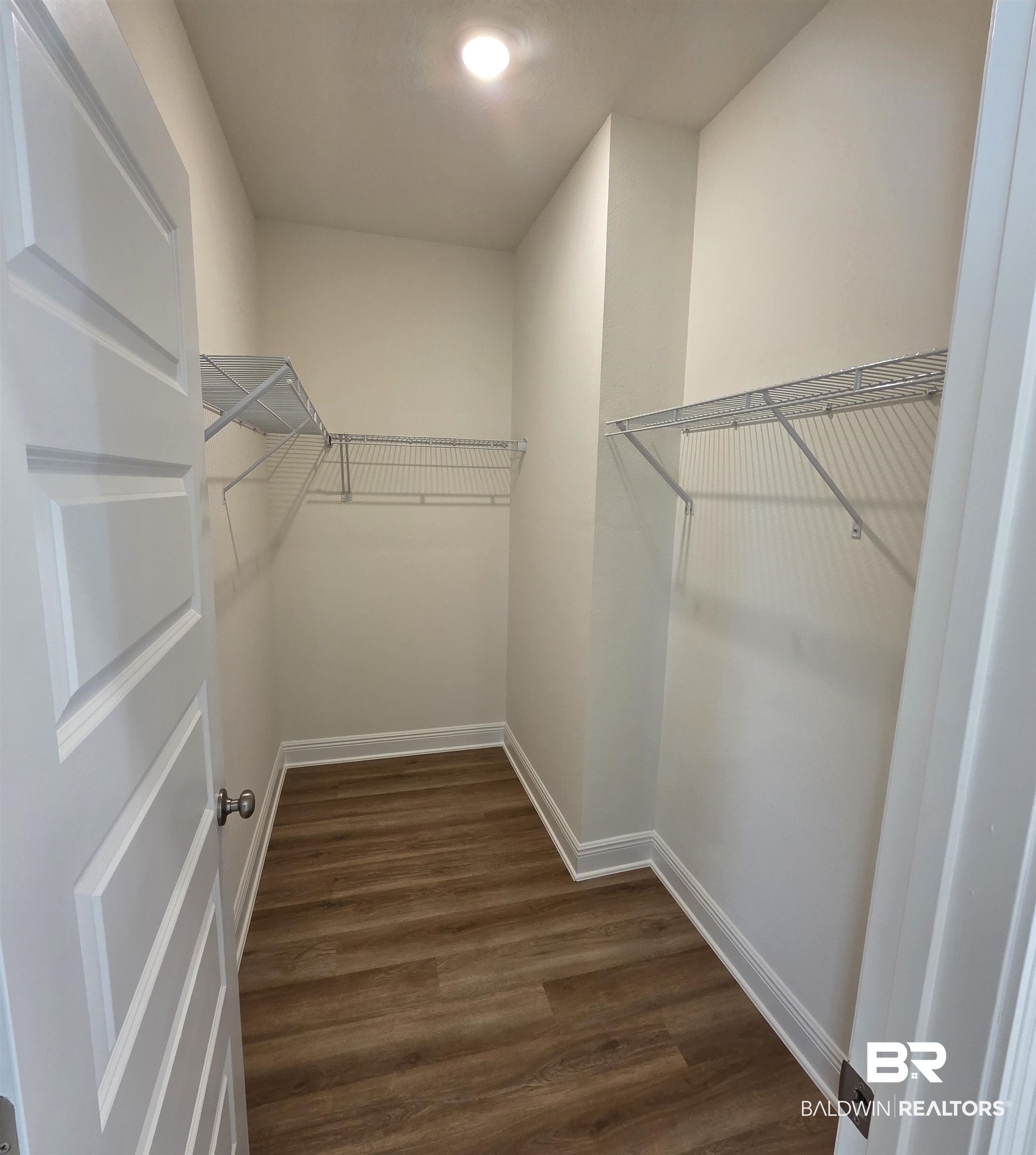 28084 Hallow Trail Elberta, AL 36530 - Photo 10 of 21 Spacious closet with dark wood finished floors