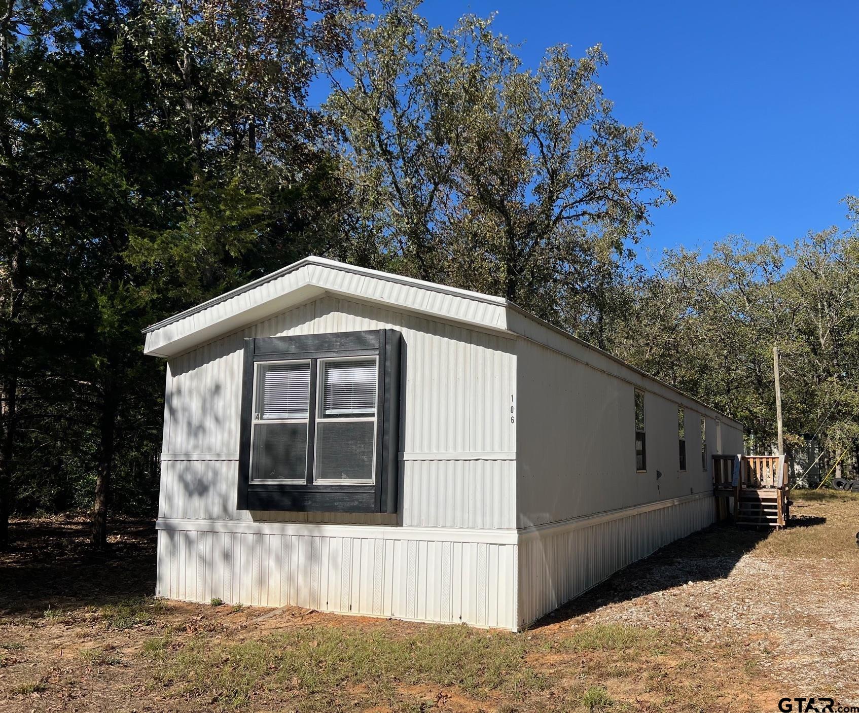 113 East Bent Bow Lane Holly Lake Ranch, TX 75765 - Photo 1 of 10 a front view of a house with a yard