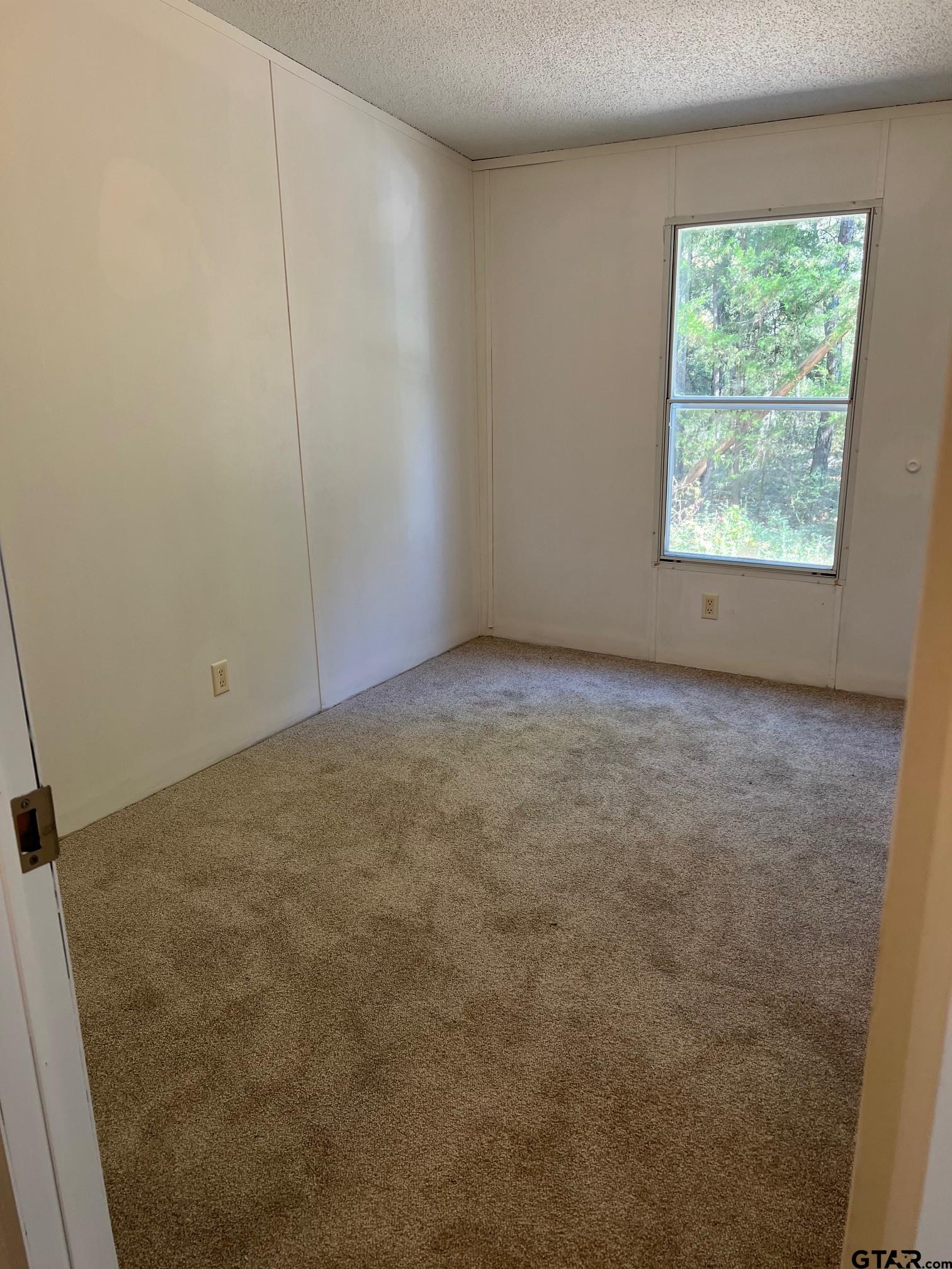 113 East Bent Bow Lane Holly Lake Ranch, TX 75765 - Photo 2 of 10 an empty room with a window