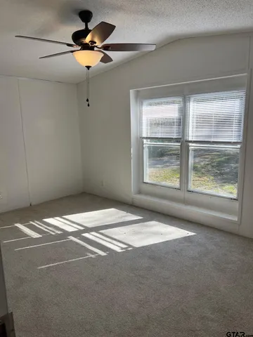 a bed sitting in a room next to a window
