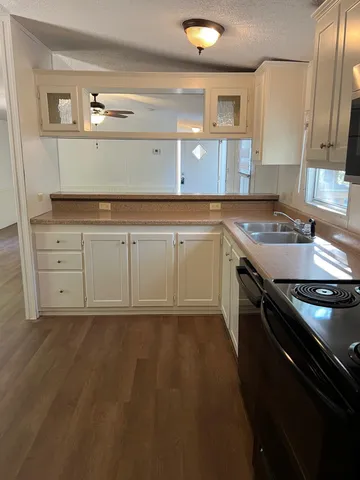 a kitchen with a sink stove and cabinets