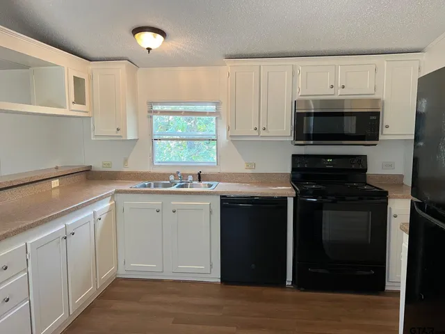a kitchen with a sink stove and microwave