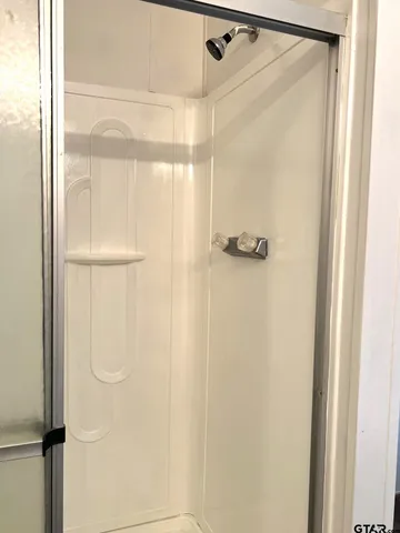 a bathroom with a glass shower door
