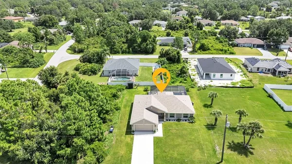 an aerial view of residential house with swimming pool and outdoor space