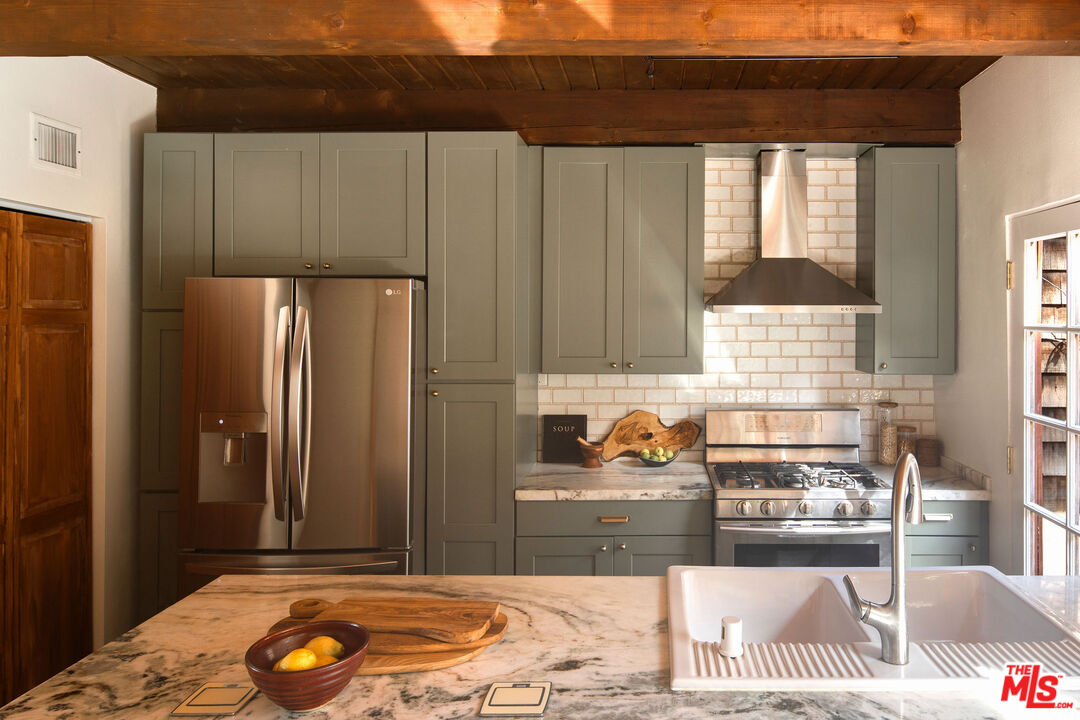 2996 Hyperion Avenue Los Angeles, CA 90027 - Photo 14 of 40 a kitchen with stainless steel appliances granite countertop a refrigerator and a sink