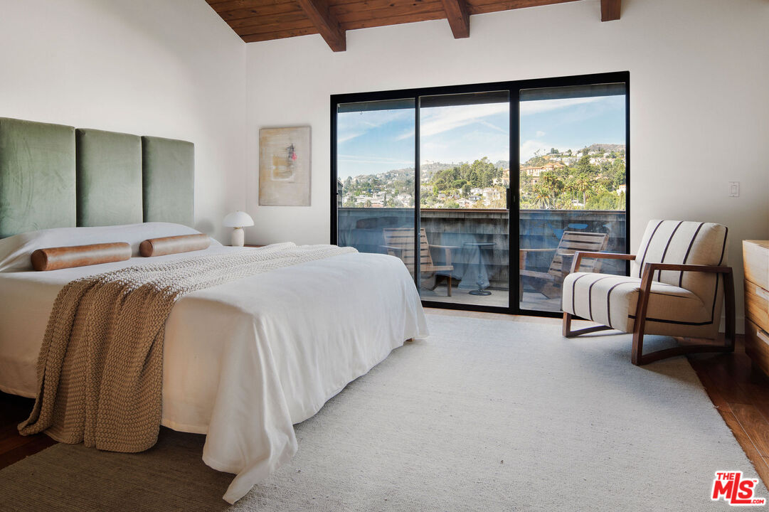 2996 Hyperion Avenue Los Angeles, CA 90027 - Photo 20 of 40 a spacious bedroom with a bed and a large window