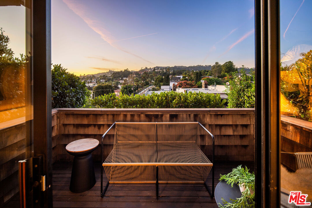 2996 Hyperion Avenue Los Angeles, CA 90027 - Photo 25 of 40 a view of a balcony with chairs and wooden floor