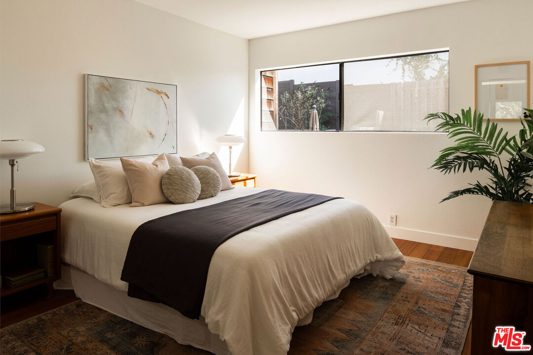 2996 Hyperion Avenue Los Angeles, CA 90027 - Photo 31 of 40 a bedroom with a large bed and a potted plant