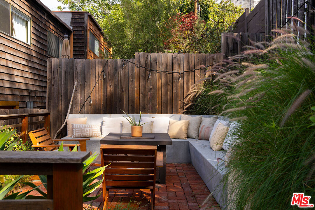 2996 Hyperion Avenue Los Angeles, CA 90027 - Photo 38 of 40 a view of a patio with table and chairs with wooden floor and fence