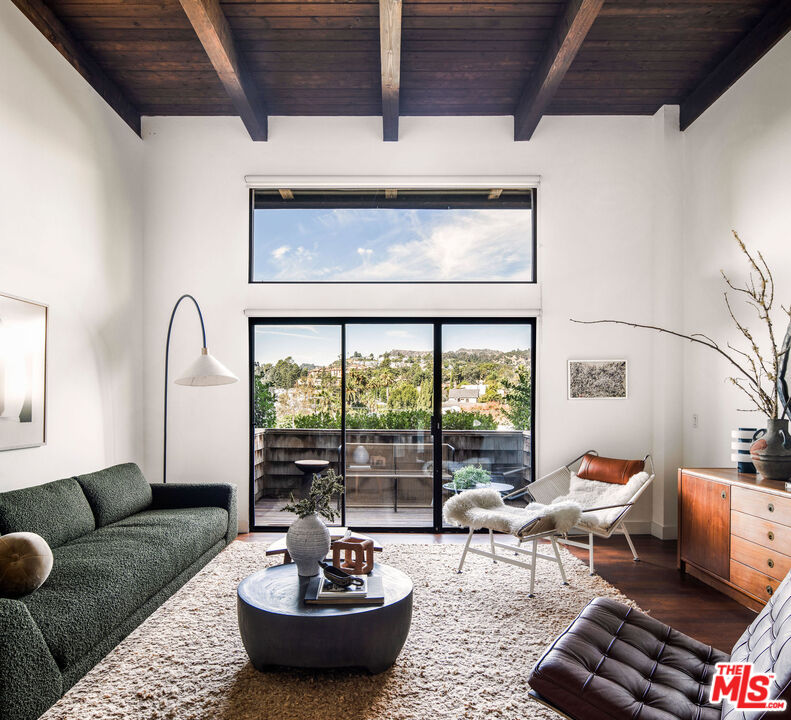 2996 Hyperion Avenue Los Angeles, CA 90027 - Photo 5 of 40 a living room with furniture and a floor to ceiling window