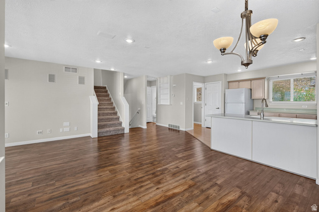 1305 Alpine Way Provo, UT 84606 - Photo 11 of 56 Open-concept living area featuring wood-finish flooring, recessed lighting, and a staircase with carpeted treads