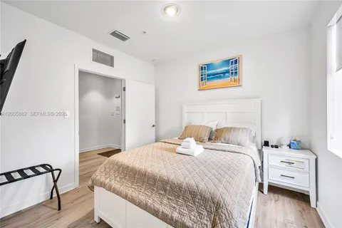 a bedroom with two beds and a large window