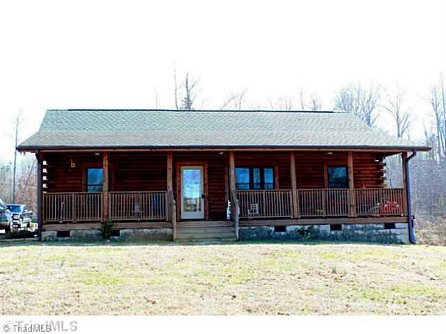 Exterior Front. Stunning log cabin with an 8  x 42.5  rocking chair front porch.