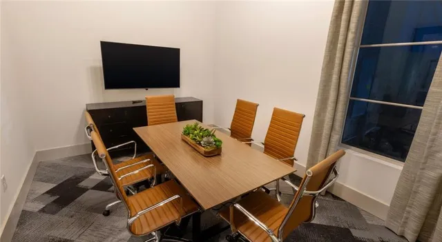 a view of a dining room with furniture and a flat screen tv