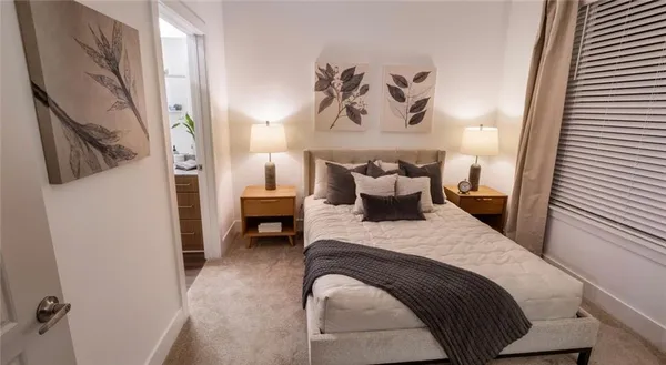 a bedroom with a bed and the view of bathroom