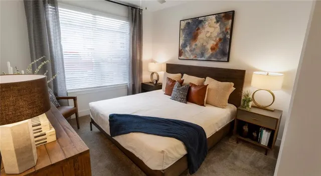 a bedroom with bed and wooden floor