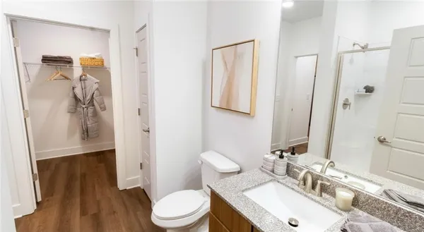 a bathroom with a sink toilet and shower