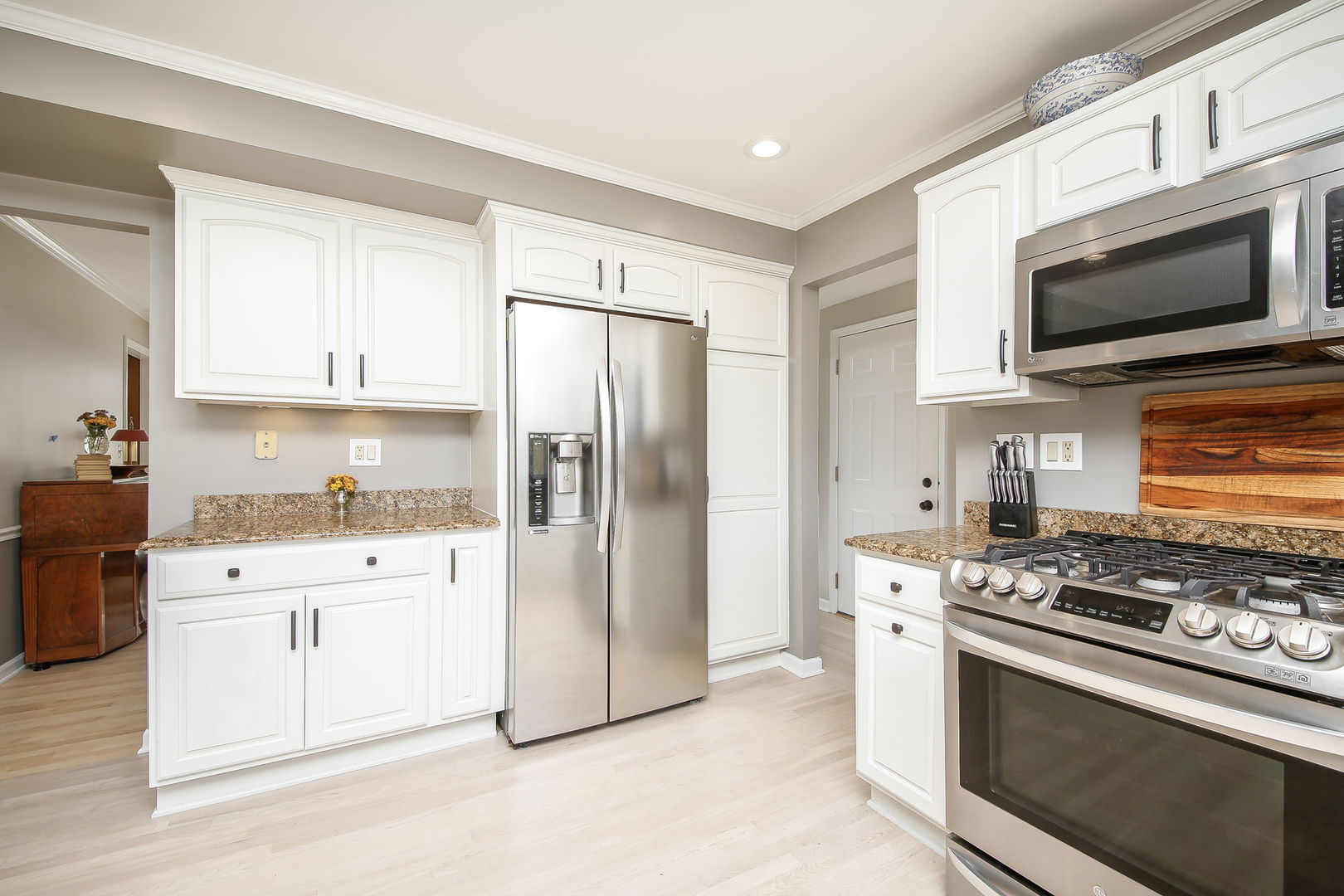 230 Hill Road Willowbrook, IL 60527 - Photo 12 of 39 a kitchen with stainless steel appliances white cabinets a stove a sink and a refrigerator