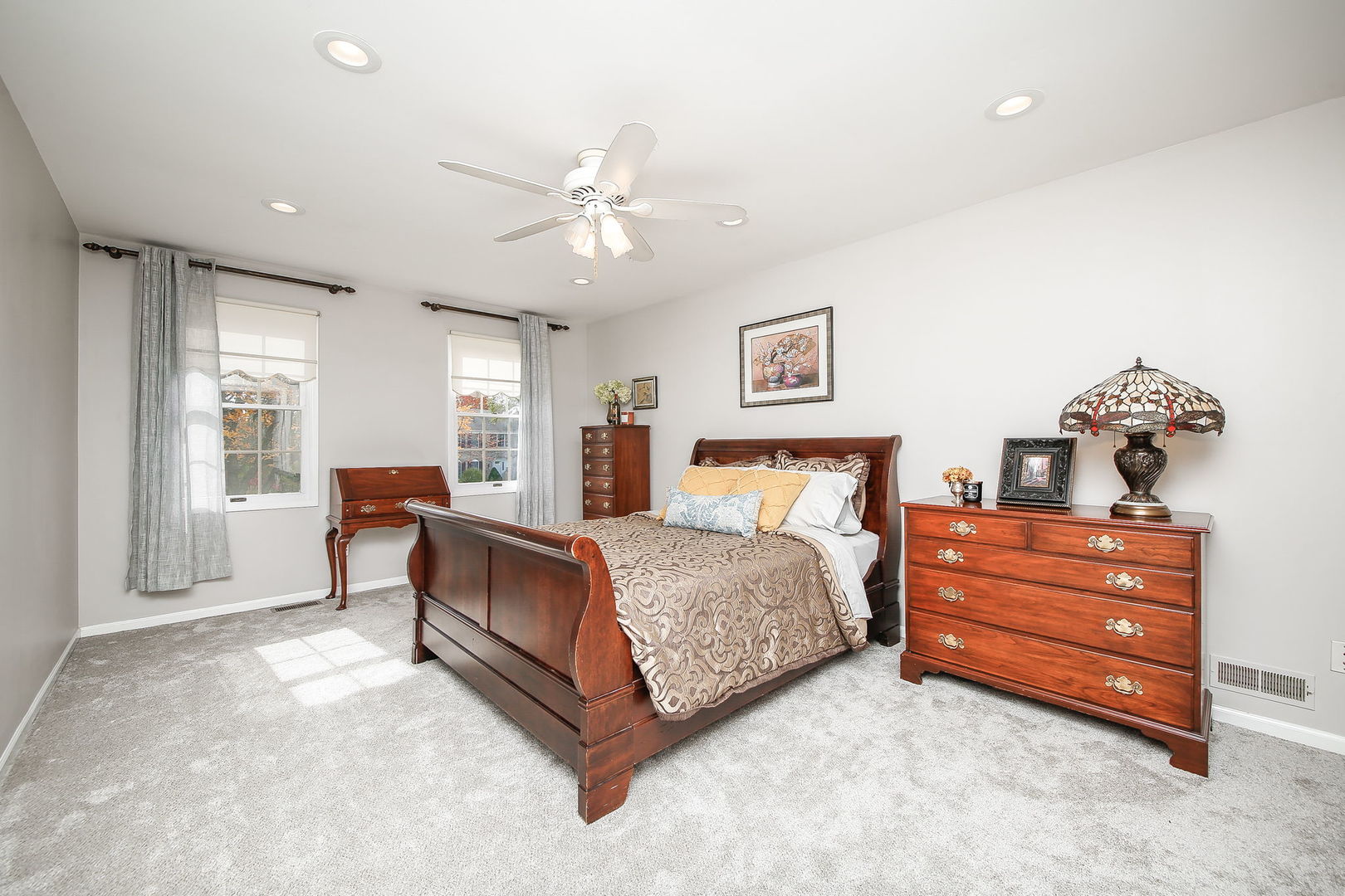 230 Hill Road Willowbrook, IL 60527 - Photo 15 of 39 a spacious bedroom with a bed and a chandelier