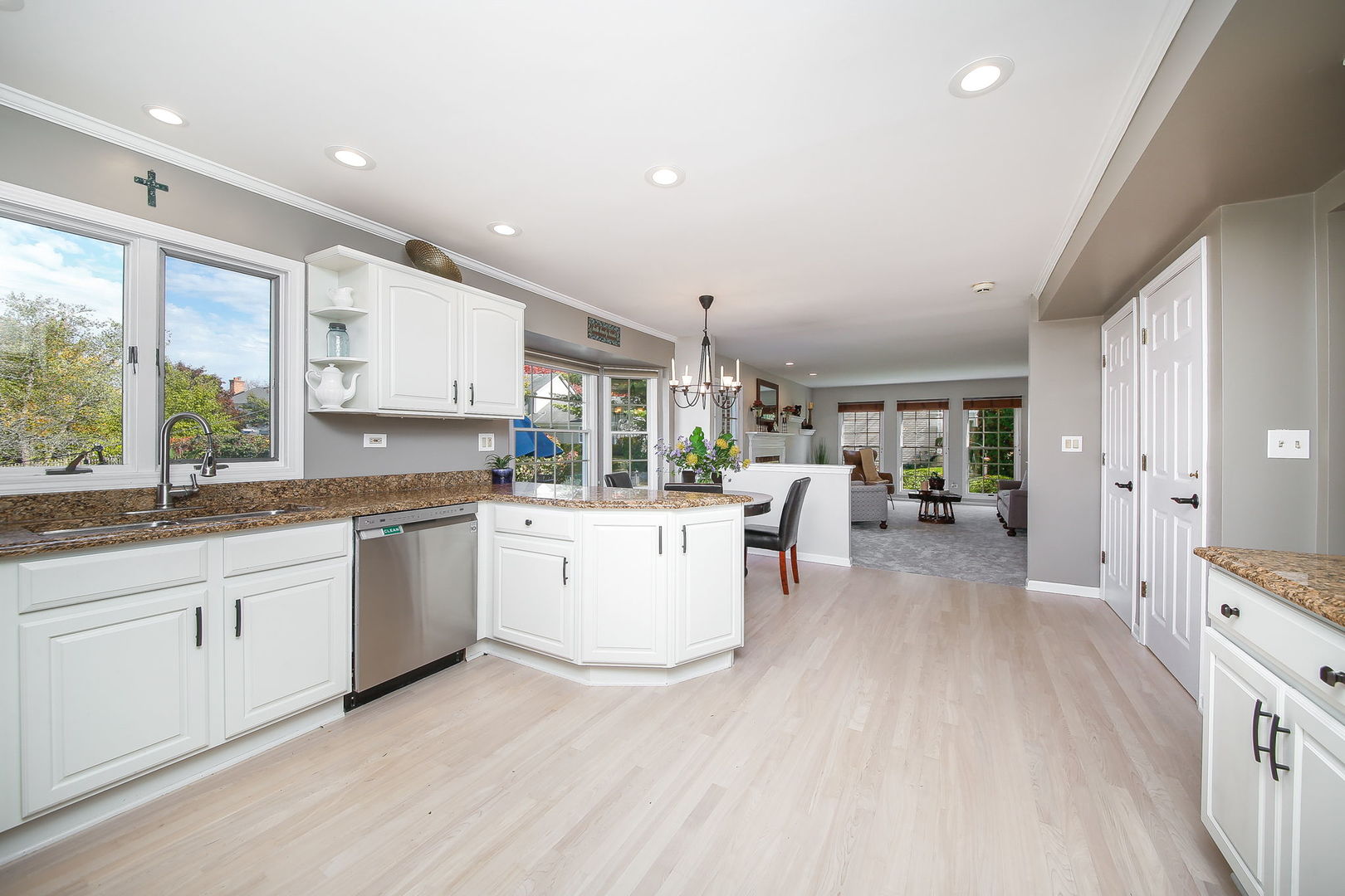 230 Hill Road Willowbrook, IL 60527 - Photo 9 of 39 a open kitchen with granite countertop a stove top oven a sink a dining table and chairs