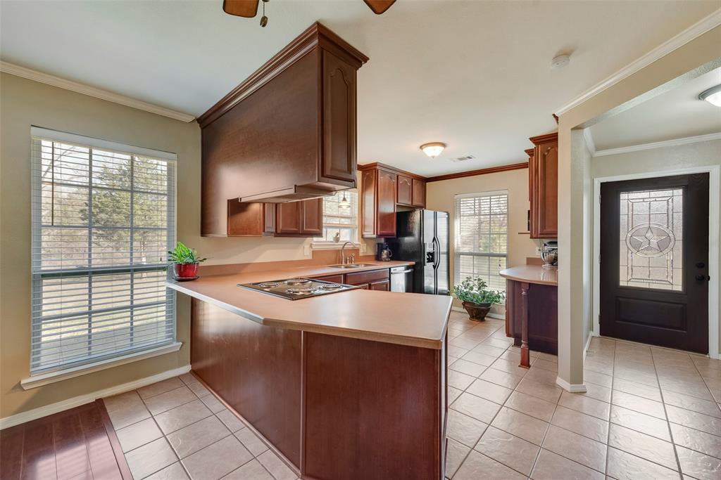 8636 Highway 31 Athens, TX 75751 - Photo 3 of 22 a kitchen with stainless steel appliances granite countertop a refrigerator and a stove top oven