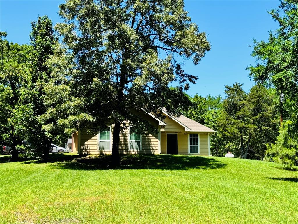 8636 Highway 31 Athens, TX 75751 - Photo 9 of 22 a front view of a house with yard and green space