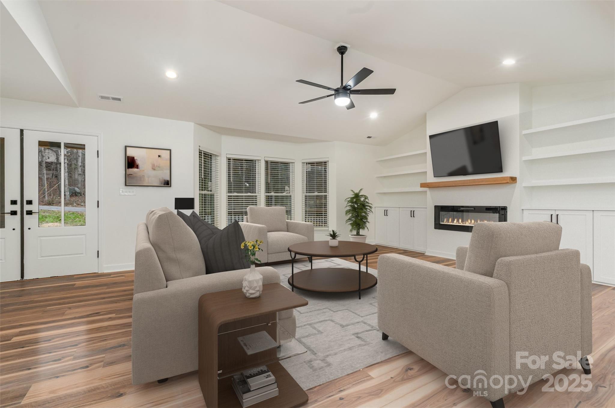 a living room with furniture and a flat screen tv