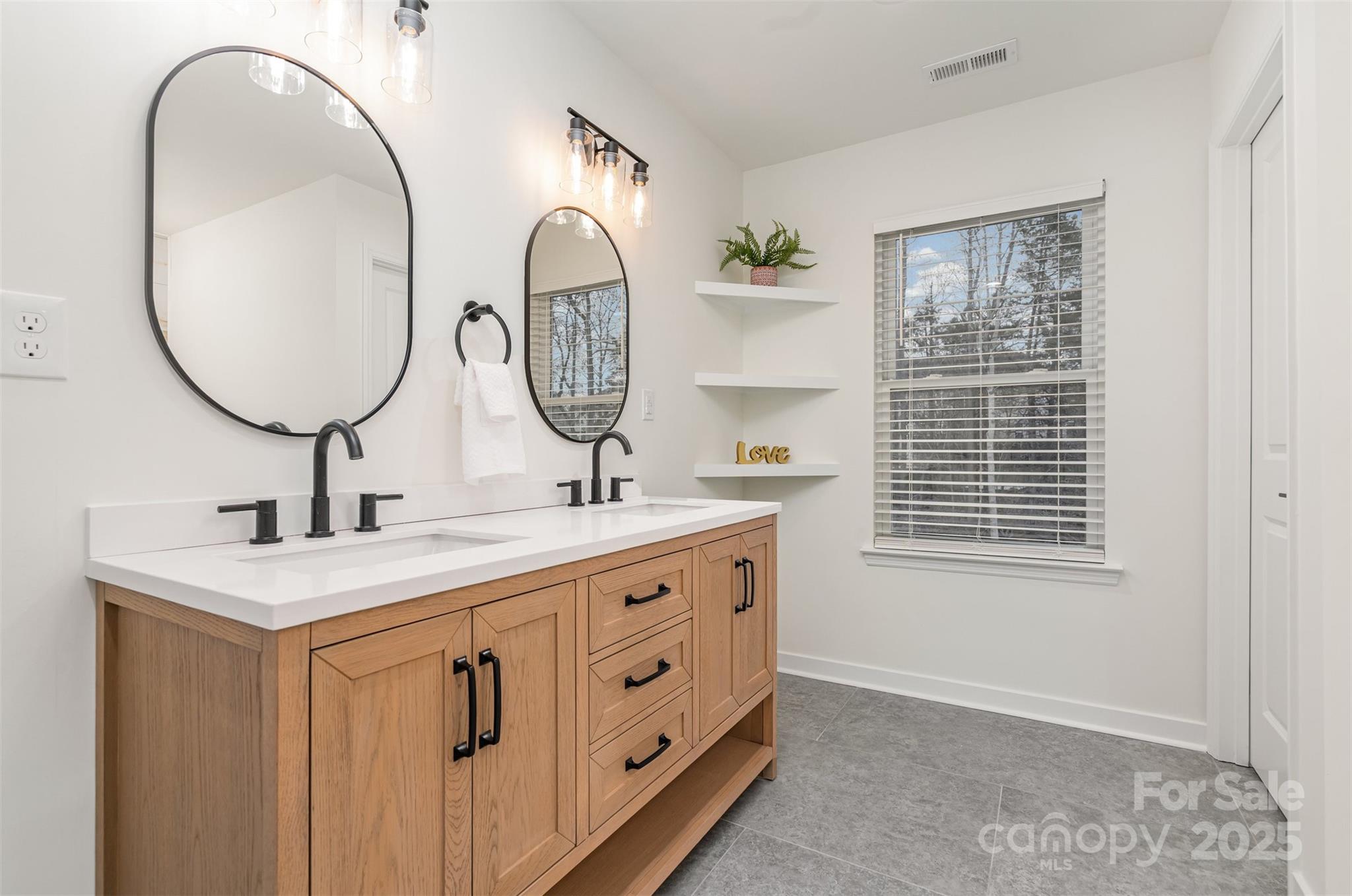 4169 Stack Road Harrisburg, NC 28075 - Photo 16 of 29 a bathroom with a double vanity sink and a mirror