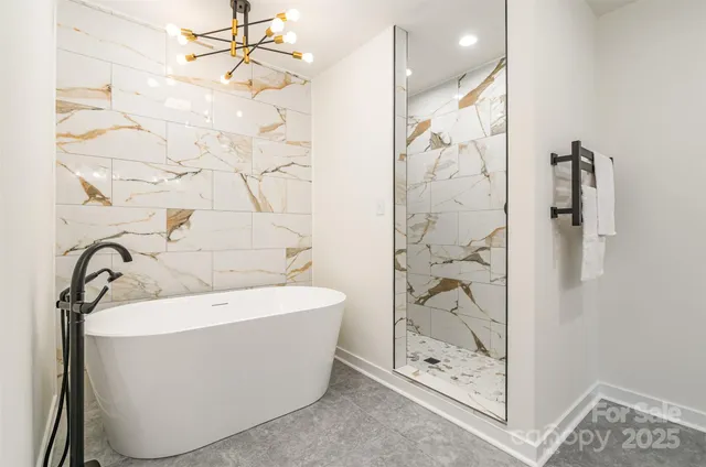 a bathroom with a bathtub and shower