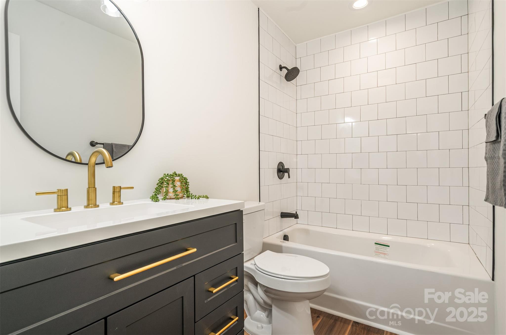 4169 Stack Road Harrisburg, NC 28075 - Photo 19 of 29 a bathroom with a sink a toilet and bathtub