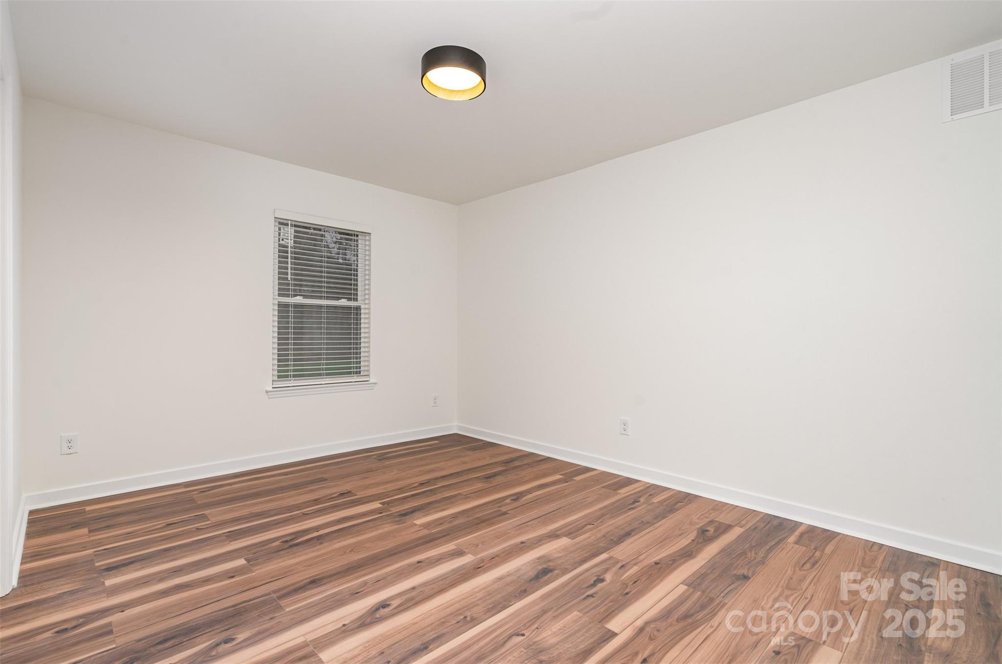 4169 Stack Road Harrisburg, NC 28075 - Photo 21 of 29 a view of empty room with wooden floor
