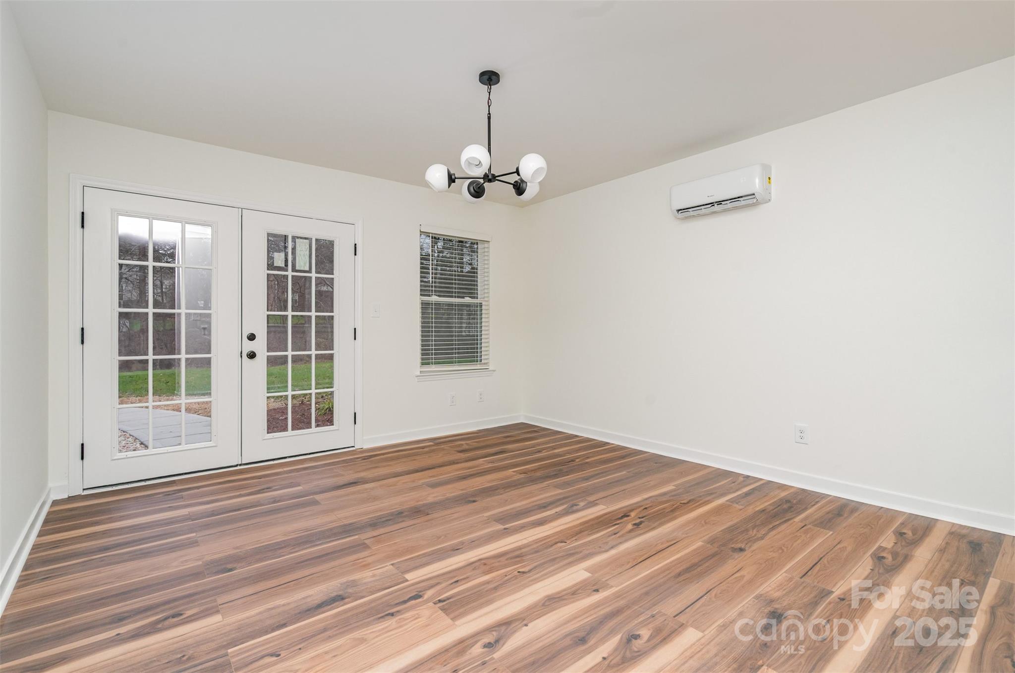 4169 Stack Road Harrisburg, NC 28075 - Photo 23 of 29 a view of empty room with wooden floor and fan