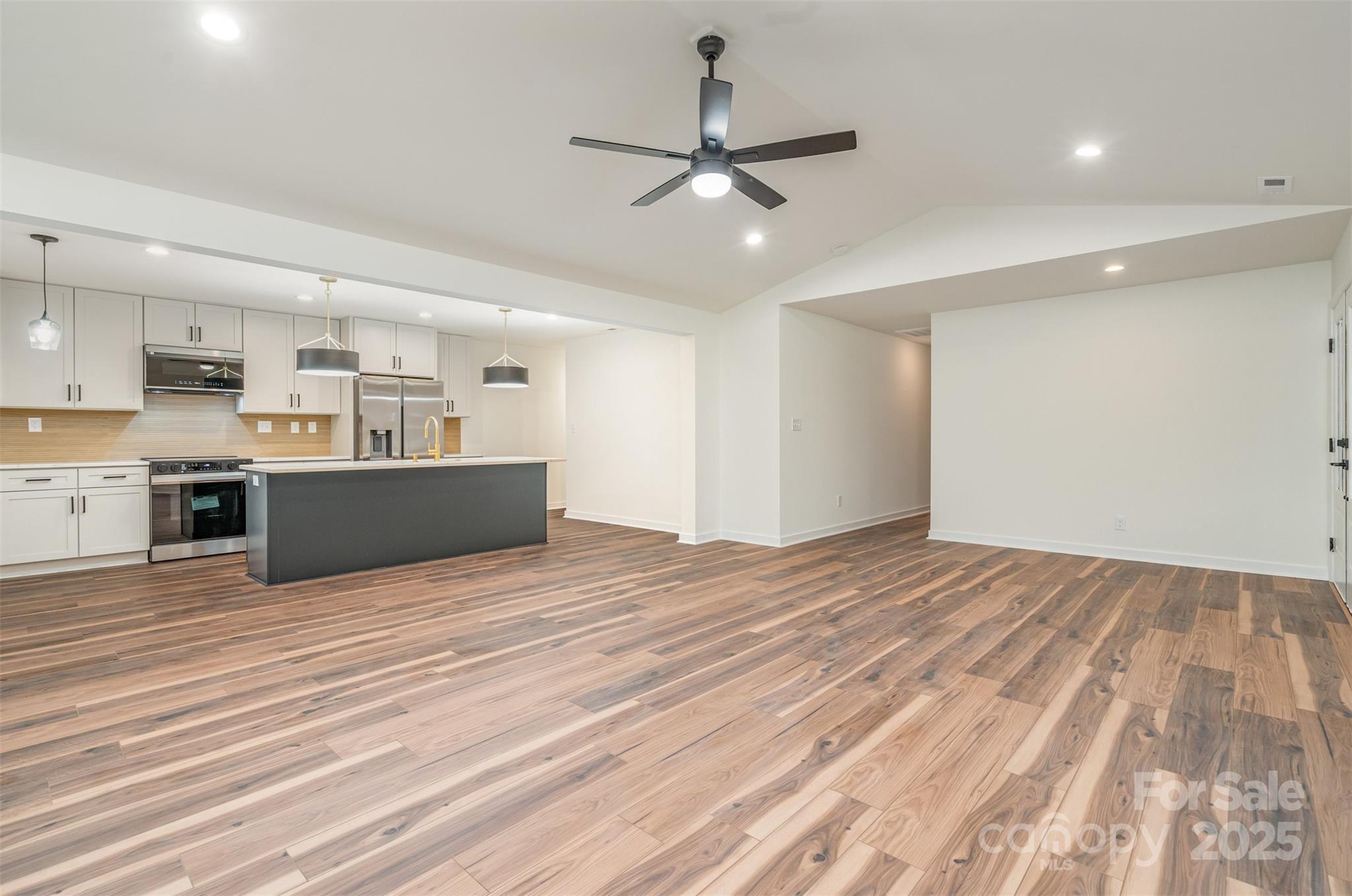 4169 Stack Road Harrisburg, NC 28075 - Photo 10 of 29 a view of a kitchen with a stove cabinets and wooden floor