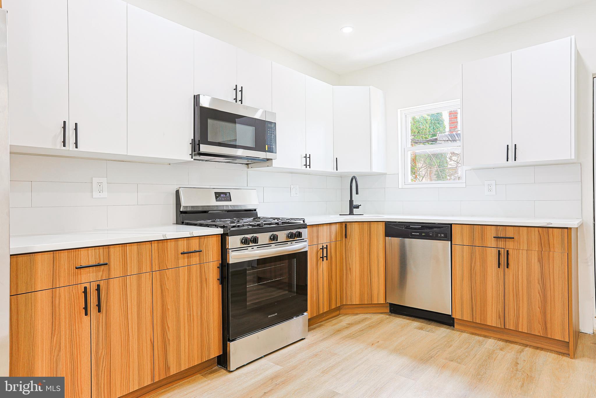 5520 Pemberton Street Philadelphia, PA 19143 - Photo 1 of 28 a kitchen with stainless steel appliances granite countertop a stove a sink and a microwave