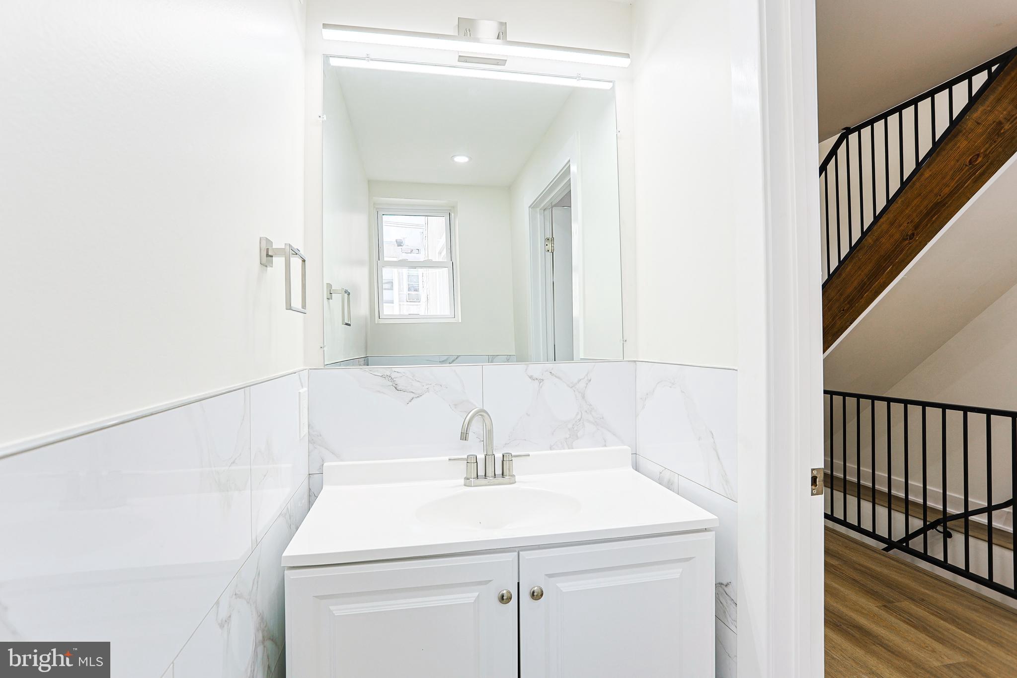 5520 Pemberton Street Philadelphia, PA 19143 - Photo 11 of 28 a bathroom with a sink and a mirror