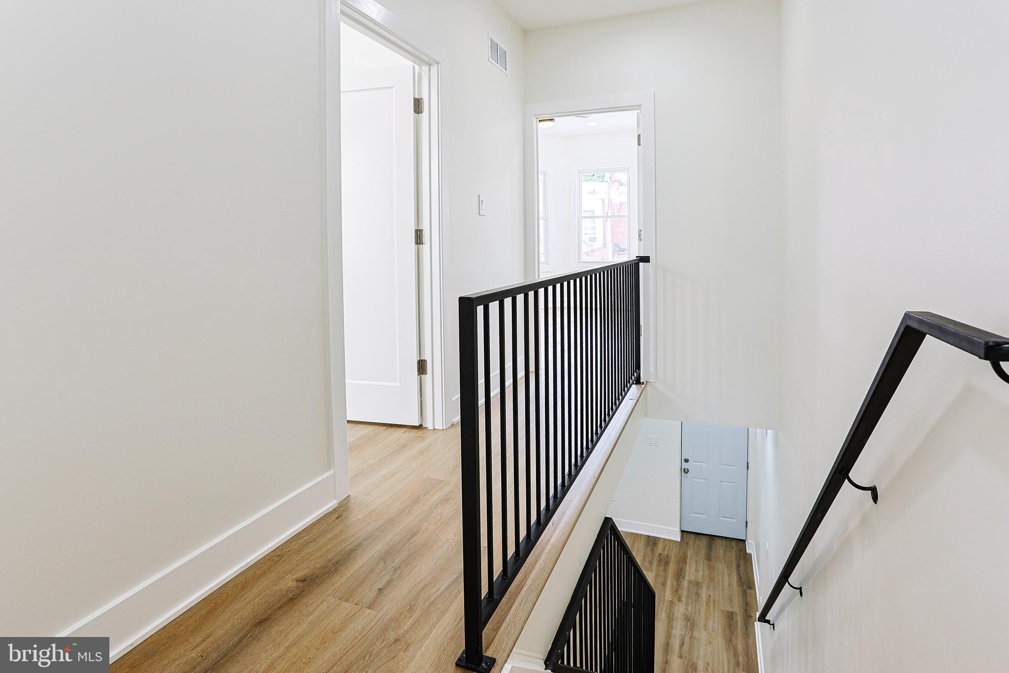 5520 Pemberton Street Philadelphia, PA 19143 - Photo 12 of 28 a view of a hallway with wooden floor and staircase