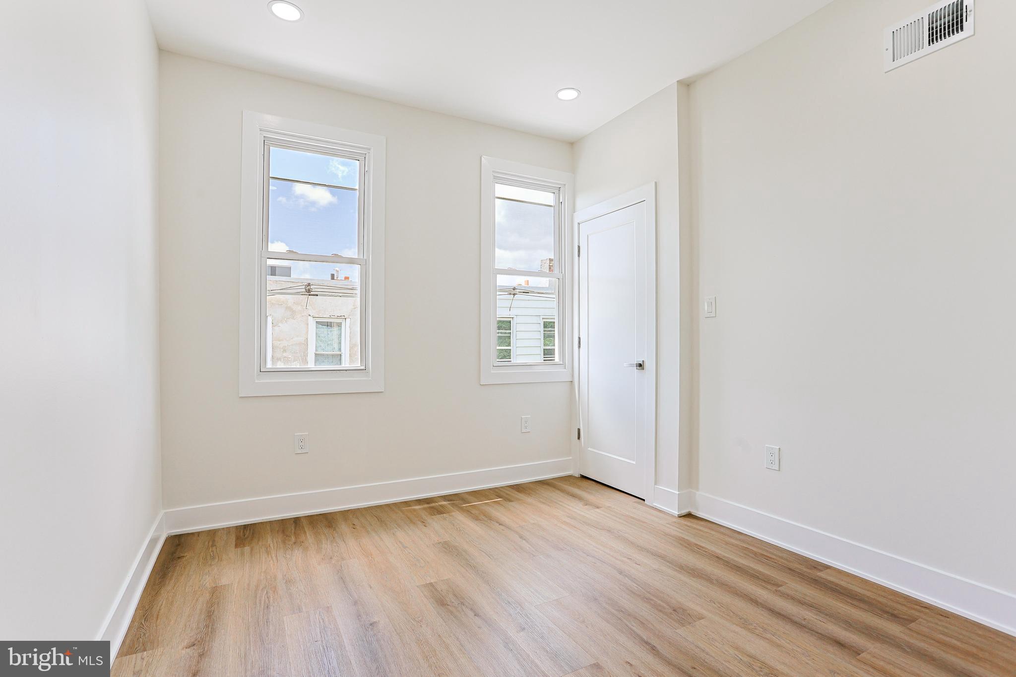 5520 Pemberton Street Philadelphia, PA 19143 - Photo 13 of 28 an empty room with wooden floor and windows